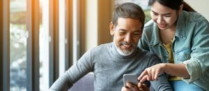 Homeowners engaging with HOA management app on a mobile phone, staying informed about their community's updates and services