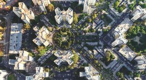 Aerial view of a modern urban environment with highrises, showcasing cityscape and urban development for real estate and community management insights.